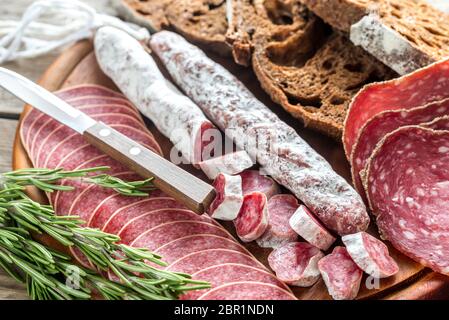 Different kinds of salami with dark-rye bread Stock Photo