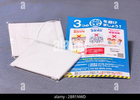 tokyo, japan - may 20 2020: Cloth masks and leaflet promoting social distancing sent by Japanese govt of Abe Shinzo to cope with the chronic shortage Stock Photo