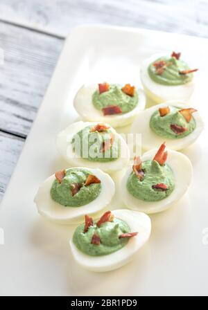 Spinach and bacon deviled eggs Stock Photo