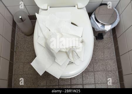 An Overhead View Of Used Crumpled White Toilet Paper Inside The Toilet Bowl Stock Photo