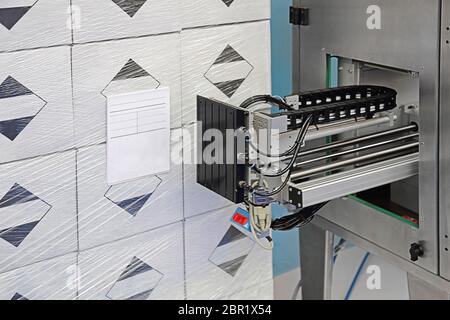 Automated Pallet Labeling Machine in Factory Stock Photo