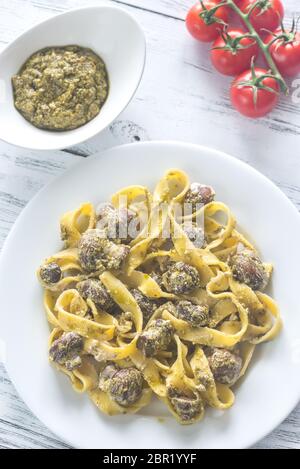 Portion of fettuccine with creamy mushroom sauce and pesto Stock Photo