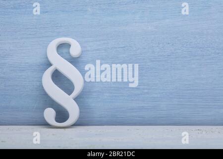Close-up Of A Paragraph Symbol Leaning On Blue Wall