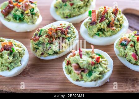 Bacon guacamole deviled eggs Stock Photo