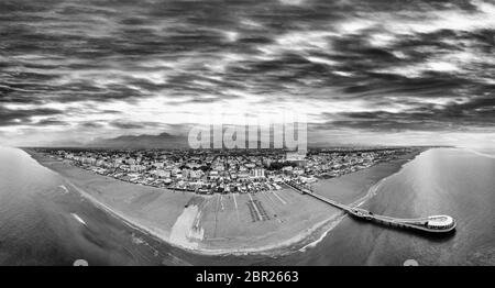 Amazing sunset aerial view of beautiful Lido Di Camaiore coastline. Tuscany coastline in summer season, black and white view. Stock Photo