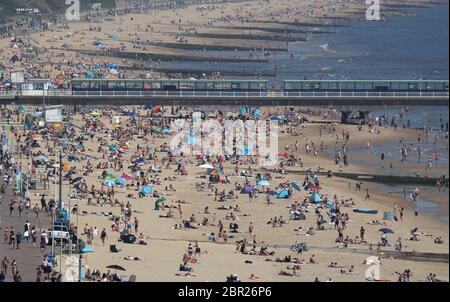 People enjoy the hot weather at Bournemouth beach in Dorset, as people flock to parks and beaches with lockdown measures eased. Stock Photo