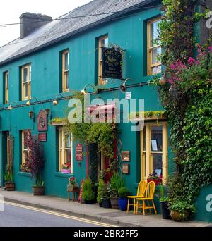 Front view of a colourful brightly painted green guesthouse in Skibbereen County Cork Ireland. Stock Photo