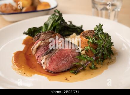 Loin of roasted Texel lamb with celeriac puree and kale Stock Photo