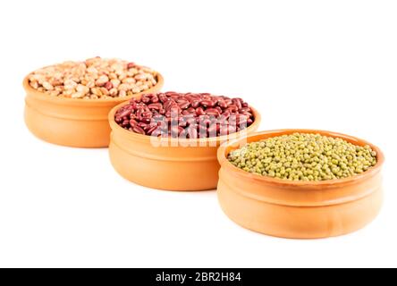 Red kidney, borlotti and mung beans in the ceramic pots isolated on a white background. Stock Photo