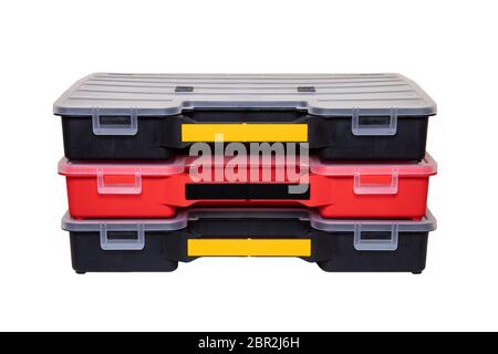 Equipment of craftsman. Three professional plastic storage boxes for screws, bolts, dowels and some other components isolated on a white background. H Stock Photo