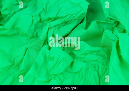 Crumpled green crepe paper texture as a background. Stock Photo