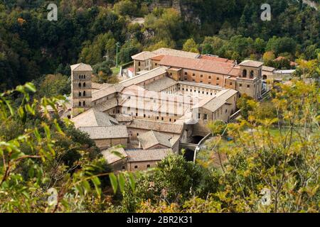 View of Saint Scholastica medieval monastery surrounded, by trees in Subiaco. Founded by Benedict of Nursia Stock Photo