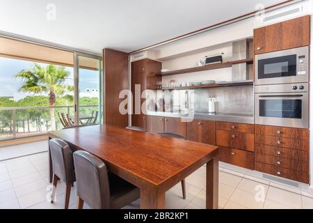 Modern kitchen, with terrace and nature view. Stock Photo