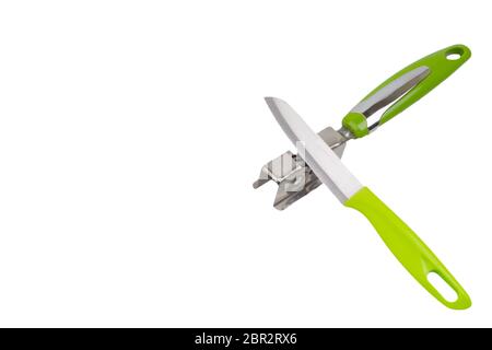 Knife, kitchen tools and knife sharpener isolated on white background. Selective focus and crop fragment Stock Photo