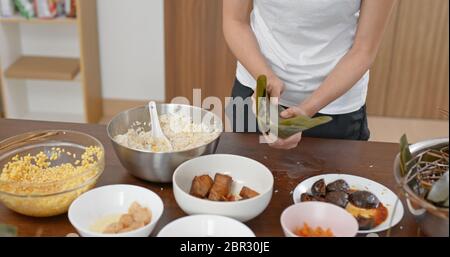 Woman wrap rice dumpling at home Stock Photo