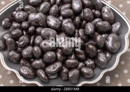 pebble chocolates in a fantasy box. chocolate nuts. chocolate coated raisins in a shell Stock Photo