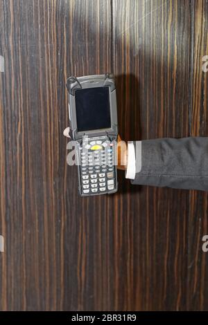 Man Holding Handheld Barcode Scanner Reader Stock Photo