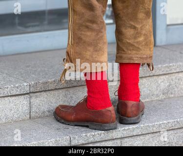 Man in traditional Bavarian leather trousers Lederhosen and red socks Stock Photo