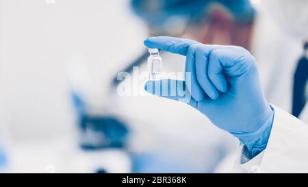 close up. vial with a vaccine in the hands of a scientist. Stock Photo
