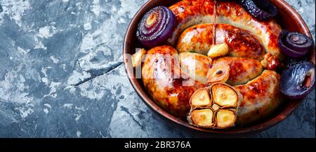 Fried sausages.Grilled sausage with garlic and onions Stock Photo
