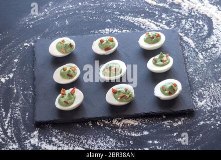 Spinach and bacon deviled eggs Stock Photo