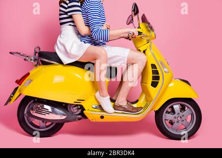 Cropped profile side view portrait of his he her she nice attractive lovely couple riding moped embracing spending weekend vacation journey isolated Stock Photo