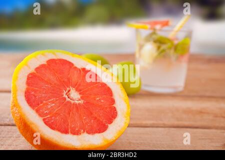 Grapefruit and lemonade or mojito cocktail with mint, cold refreshing drink or beverage with ice on the background Stock Photo