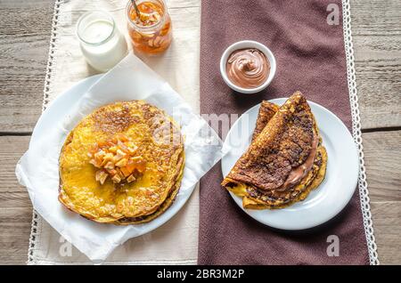 Pumpkin crepes with fruit confiture and chocolate cream Stock Photo