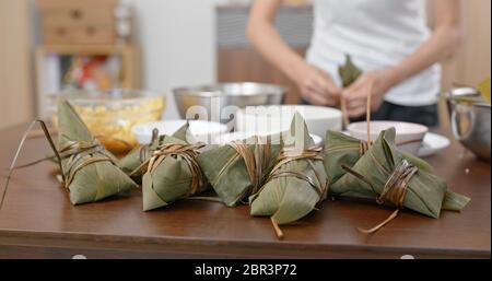 Woman wrap rice dumpling at home Stock Photo