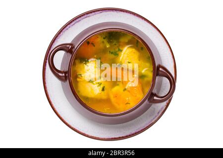 Seafood background. Macro of freshly cooked Mediterranean fish soup with salmon and shrimps in a brown ceramic bowl on plate isolated on a white backg Stock Photo