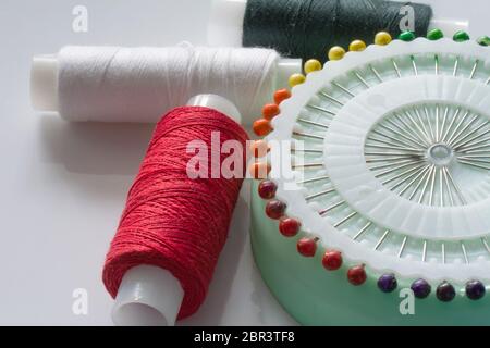 Sewing tools and kit on a white background. Accessories and equipment for needlework. Close up view Stock Photo