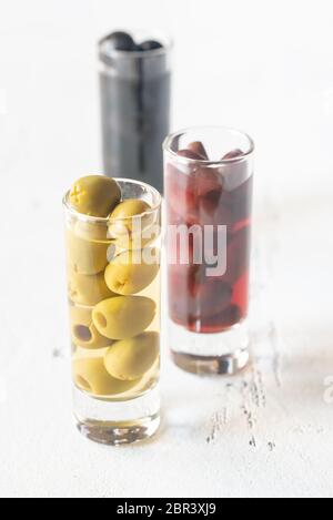 Assortment of three species of olives in glasses on the white background Stock Photo