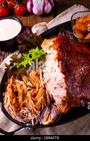 delicious pulled pork with baked potato quarters