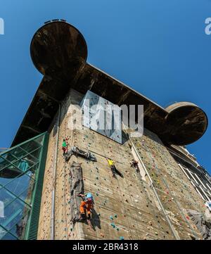 Climbing at the large artificial wall at the Seaquarium, former air Defence Tower in the 2nd World war, now a Dorado for Climbers, Vienna, Austria Stock Photo