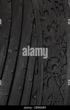 Viking ship with scandinavian patterns, close up. Ancient viking pattern on a wooden warship. Wooden texture of a Viking ship in the Viking Ship Museu Stock Photo