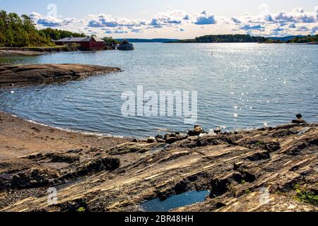 Panoramic early autumn view of rocky seashore of Hovedoya island in Oslofjord harbor near Oslo, Norway Stock Photo