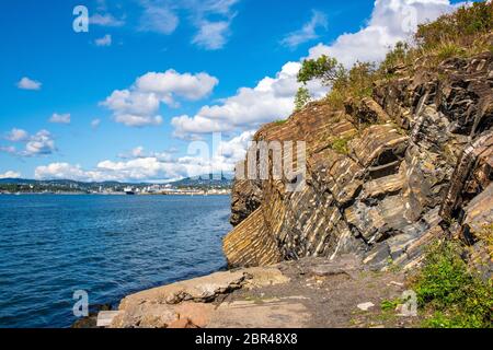 Oslo, Ostlandet / Norway - 2019/09/02: Panoramic view of Oslofjord harbor from rocky recreational cape of Hovedoya island with Londoya island in backg Stock Photo