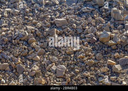 sunny illuminated full frame broken stones background Stock Photo