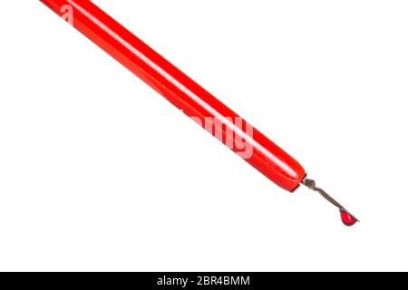 side view of ink drop in red dip pen close up isolated on white background Stock Photo