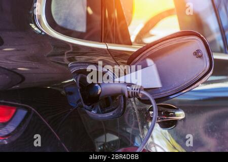 Socket plug with charging for electric car, battery charging close up view Stock Photo