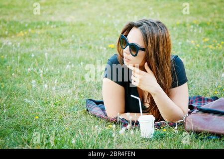 beautiful girl student lies on the grass Stock Photo