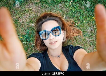 beautiful girl student lies on the grass Stock Photo