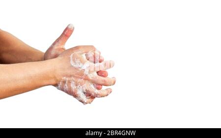 Young man wash hands with soap, closeup detail on soap bubbles, isolated on white, space for text right side. Can be used during coronavirus covid-19 Stock Photo
