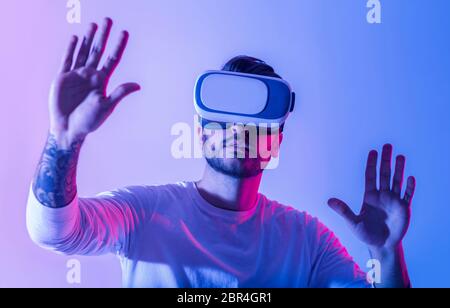 Millennial man in VR with sense of immersion in virtual environment Stock Photo