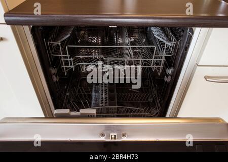 modern Half open empty dishwasher in a modern kitchen close-up Stock Photo