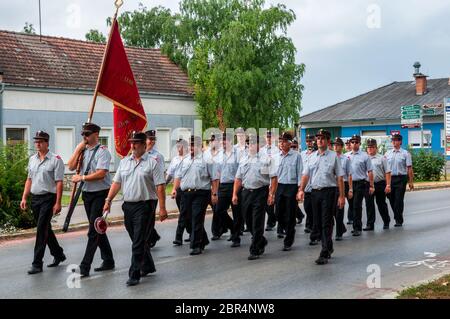 Fire brigade workers are marching on corpus christi celebration day in Andau, Burgenland Stock Photo