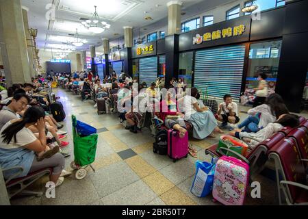 Beijing / China - July 23, 2016: People waiting for trains in Beijing main railway station Stock Photo