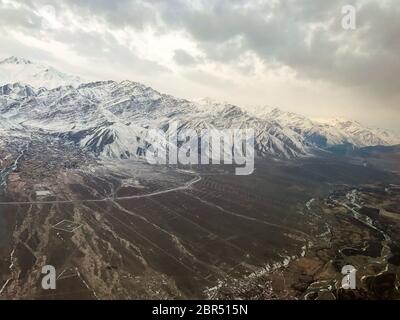 Aerial panorama view of Ladakh snow covered mountains, Jammu and Kashmir, India Asia. The white mountains look awesome from a flight from Delhi to Leh Stock Photo