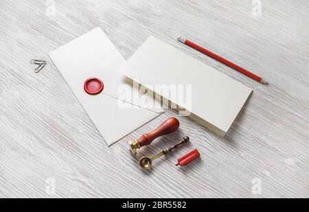 Vintage envelope and stationery on light wooden background. Responsive design mockup. Stock Photo