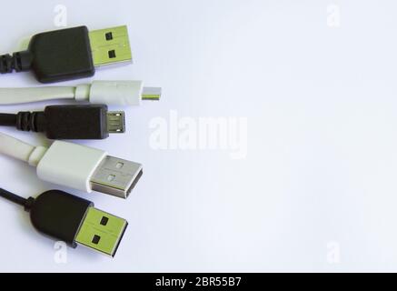 Universal USB cable in white and black for mobile phones. for connecting micro USB devices, including phones and tablets.copyspace for text Stock Photo